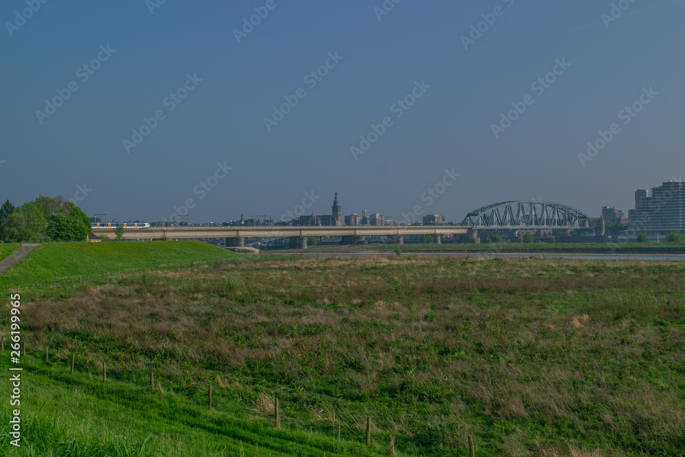 Dutch passenger train passing a bridge