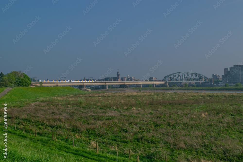 Dutch passenger train passing a bridge Dutch passenger train passing a bridge