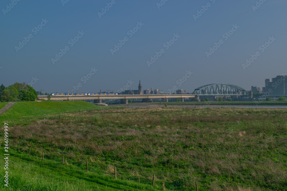 Dutch passenger train passing a bridge