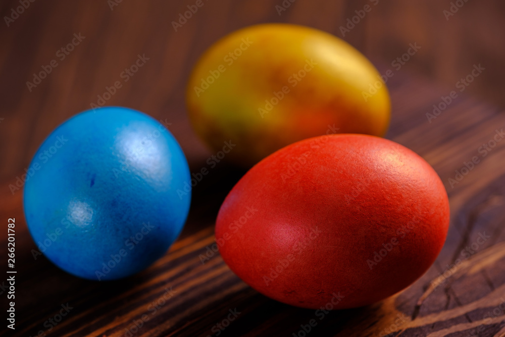 Easter cakes and colored eggs on a wooden table Easter cakes and colored eggs on a wooden table