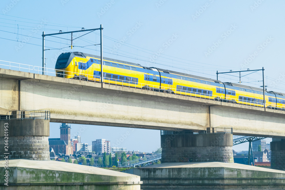 Dutch passenger train passing a bridge