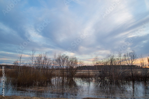 Beautiful spring landscape with clouds at sunset.