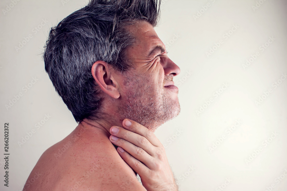 Obraz premium Man feels strong throat pain. People, healthcare and medicine concept