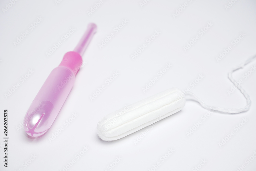 Hygienic tampon with applicator close up on white background Hygienic tampon with applicator close up on white background