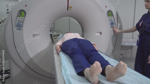 A scanning room with computers and monitors next to the CT scan room in a new modern cancer treatment hospital. 4k