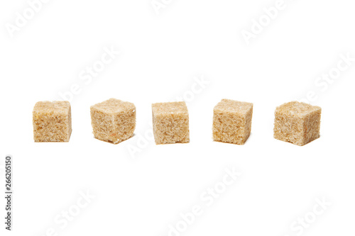 Brown cane sugar cubes isolated on white