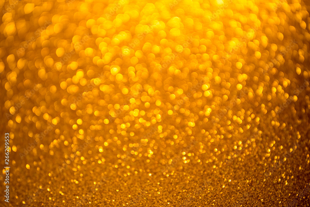 Gold glitter christmas abstract background. Defocused sequin light.