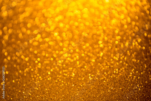 Gold glitter christmas abstract background. Defocused sequin light.