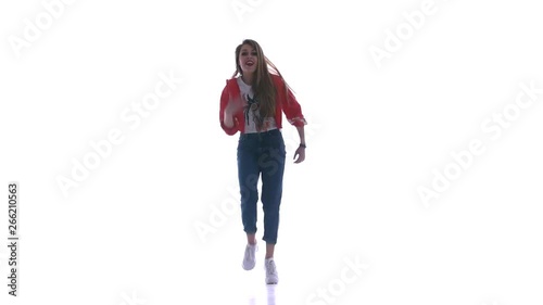 Young beautiful girl dancing hip-hop, street dancing on white background, isolated