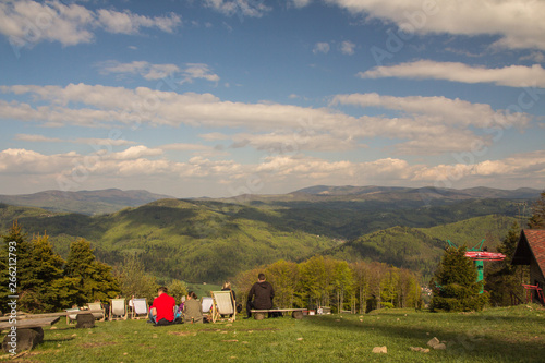 People chilling out on the sunbeds on the top of the mountain, Czantoria, Poland photo