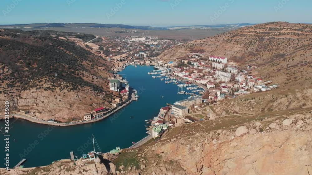 Aerial view of Balaklava landscape with boats and sea in marina bay and small town. Drone top view shot of port for luxury yachts, boats and sailboats Aerial view of Balaklava landscape with boats and sea in marina bay and small town. Drone top view shot of port for luxury yachts, boats and sailboats