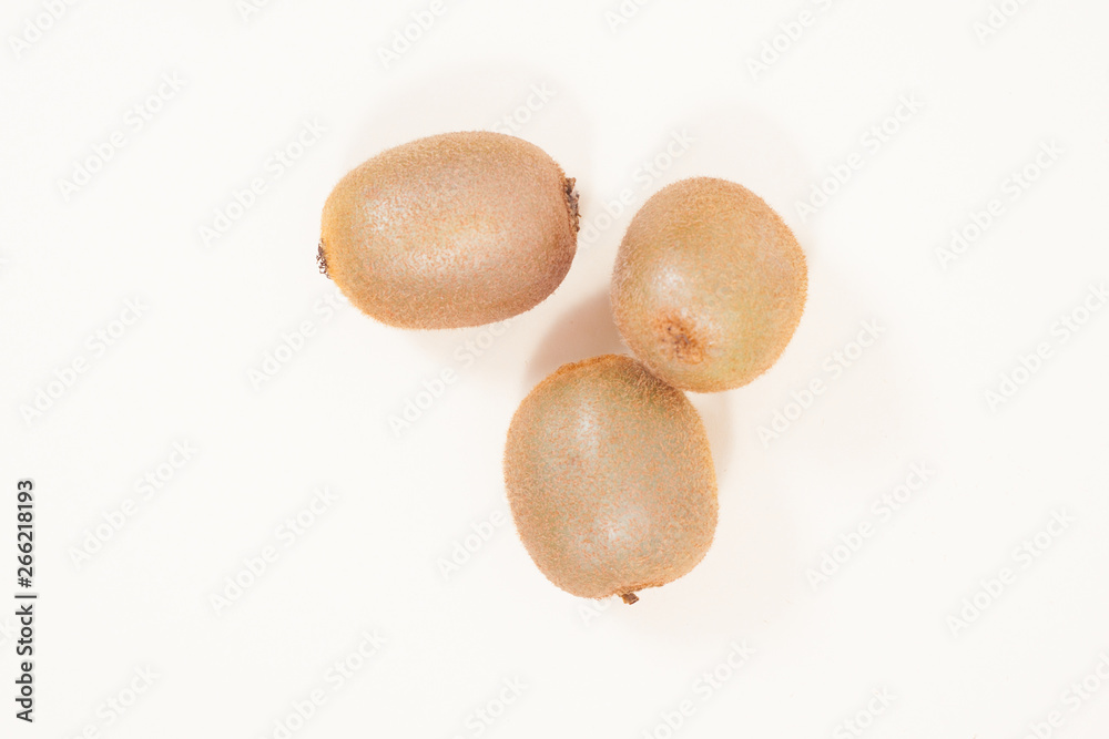 three oval kiwi fruit on a light background three oval kiwi fruit on a light background