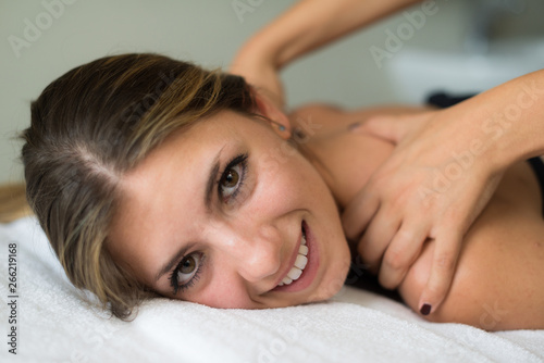 Relaxed woman receiving a massage in a spa