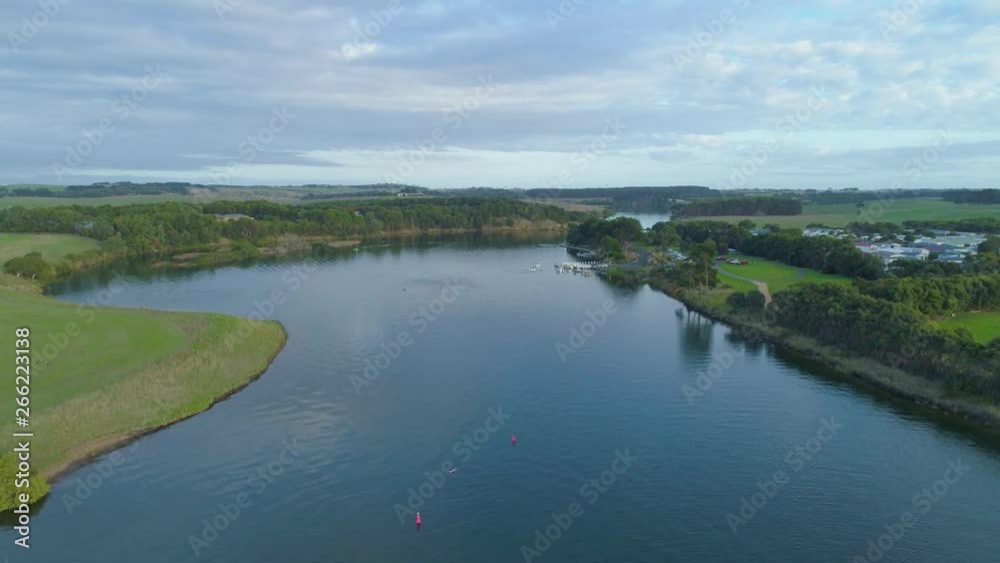 Aerial rise above scenic river revealing grasslands and fields. Warrnambool, Victoria, Australia Aerial rise above scenic river revealing grasslands and fields. Warrnambool, Victoria, Australia