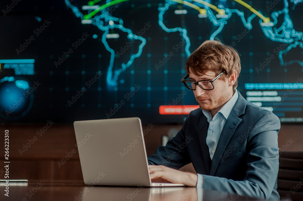 Young it engeneer business man with thin modern aluminium laptop in network server room Young it engeneer business man with thin modern aluminium laptop in network server room