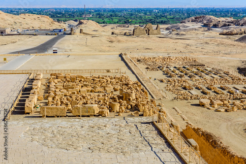 Archeological site near the temple of Hatshepsut in Luxor, Egypt. Green landscape on a background