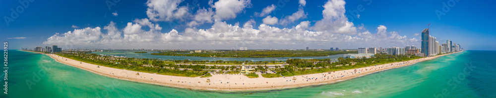 Aerial panorama Miami Beach Haulover with blue cloudy sky coastline scene