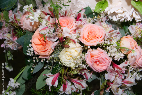 Close-up of bouquet of yellow  pink and coral roses.