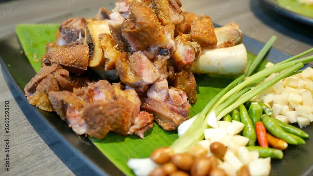 Modern thai food Deep fried pork leg served with sour and spicy dipping sauce. Modern thai food Deep fried pork leg served with sour and spicy dipping sauce.