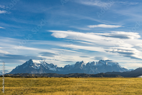 Beautiful panoramic view of golden yellow grass with background of nature cuernos mountains peak with cloud in autumn, Torres del Paine national park, south Patagonia, Chile