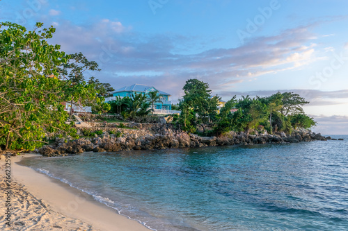 Beautiful white sand beach on upscale modern residential neighborhood property with colorful houses/ homes, on Caribbean island. Seaside/ ocean view luxury real estate. © Enrico
