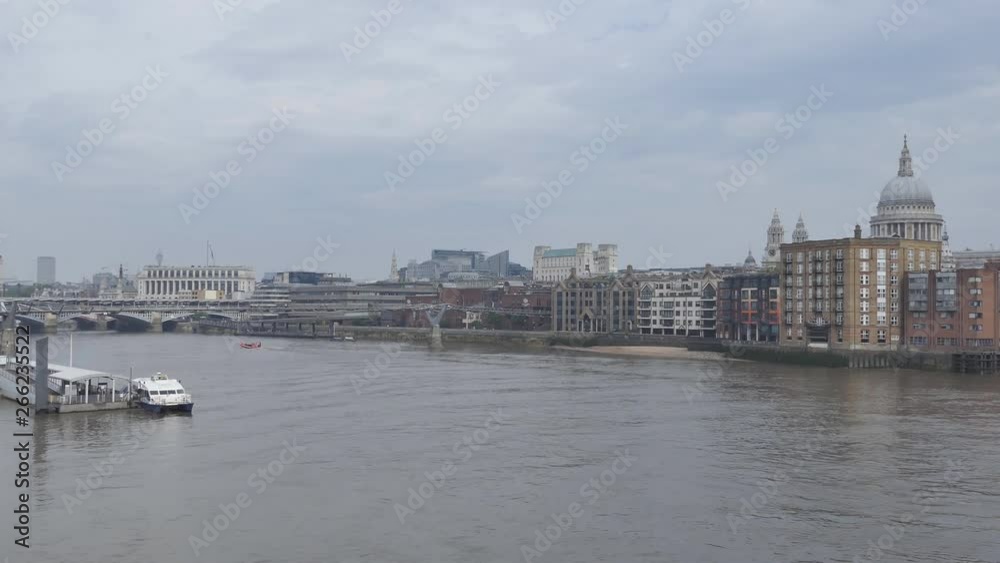 View of the Thames river with buildings in the background. View of the Thames river with buildings in the background.