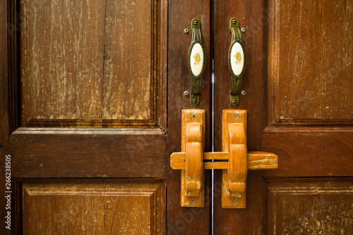 Lock on the door of an wooden house photo