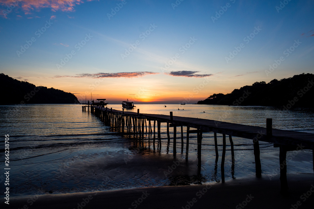 Wood bridge on the sea with a beautiful sunset at koh kood island, Thailand