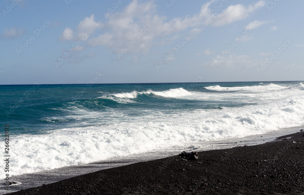 Rough surf  at edge of black sands of Pohoiki  beach