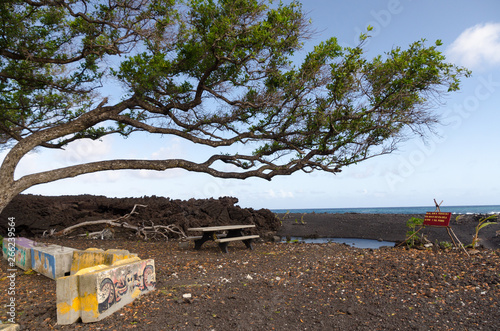 Lava rock wall at Pohoiki  beach photo