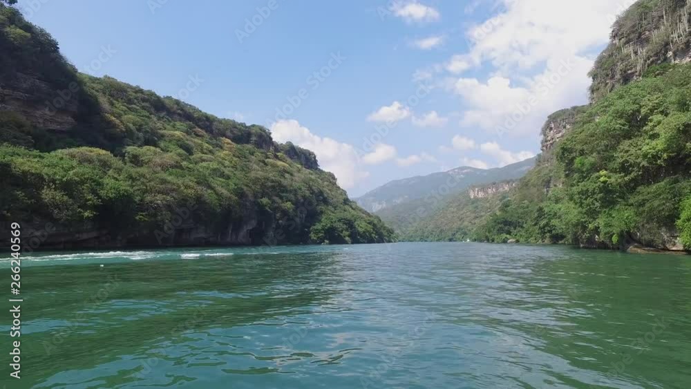 Aerial wide shot of a boat on the Grijalva river in the Sumidero Canyon in Chiapas Mexico Aerial wide shot of a boat on the Grijalva river in the Sumidero Canyon in Chiapas Mexico