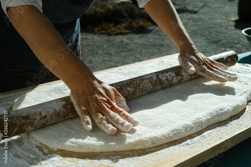 Mochi being rolled flat, before being separated into balls