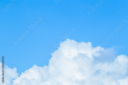 Floating white clouds and bright blue sky background