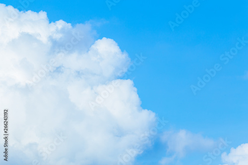 Floating white clouds and bright blue sky background