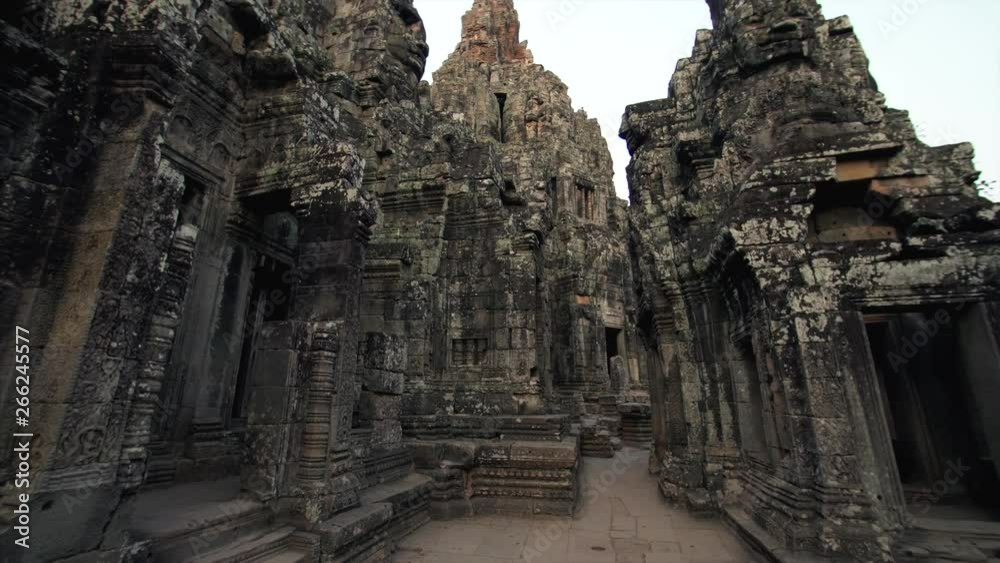 View from below of impressive high towers of Bayon temple built in the late 12th by khmer civilization and richly decorated. Angkor Wat complex, Cambodia View from below of impressive high towers of Bayon temple built in the late 12th by khmer civilization and richly decorated. Angkor Wat complex, Cambodia