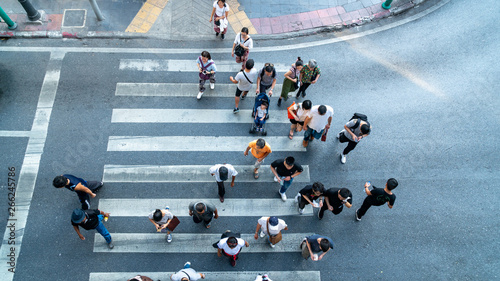 people are moving across the pedestrian crosswalk in the city road (on top view)