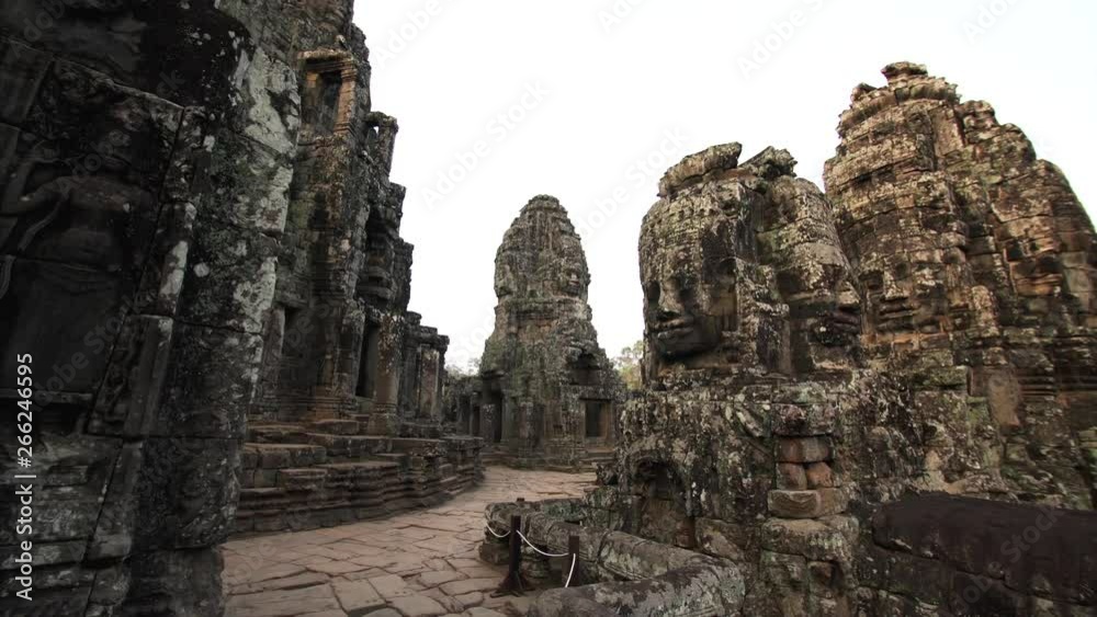 Sliding view of beautifully decorated Bayon temple and giant faces depicting Bodhisattva Avalokiteshvara. Angkor Wat complex, Cambodia Sliding view of beautifully decorated Bayon temple and giant faces depicting Bodhisattva Avalokiteshvara. Angkor Wat complex, Cambodia