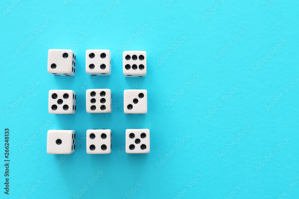 Rolling Dices over blue background. Casino gambling concept Rolling Dices over blue background. Casino gambling concept