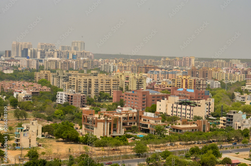 Aerial shot Cityscape in Gurgaon, Noida, Jaipur, Delhi, Lucknow, Mumbai, Bangalore, Hyderabad showing small houses, sky scrapers and other infrastructure of the business district in the urban areas. 
