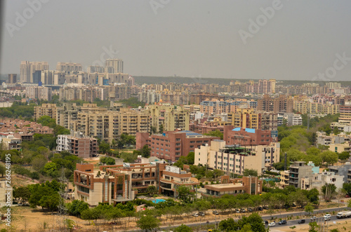 Aerial shot Cityscape in Gurgaon, Noida, Jaipur, Delhi, Lucknow, Mumbai, Bangalore, Hyderabad showing small houses, sky scrapers and other infrastructure of the business district in the urban areas. 