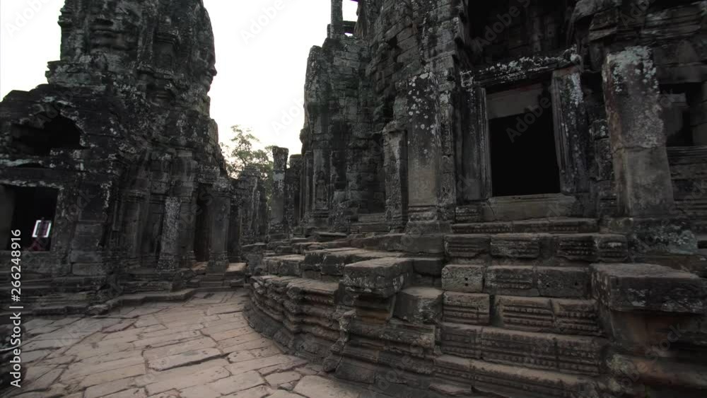 Panoramic view of richly decorated ancient Bayon temple and giant faces depicting Bodhisattva Avalokiteshvara. Angkor Wat complex, Cambodia Panoramic view of richly decorated ancient Bayon temple and giant faces depicting Bodhisattva Avalokiteshvara. Angkor Wat complex, Cambodia