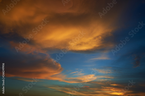 Beautiful vibrant orange cloud and blue sunset sky . © jamesteohart
