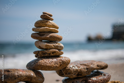 Tablou canvas cairn on sea background. pyramid
