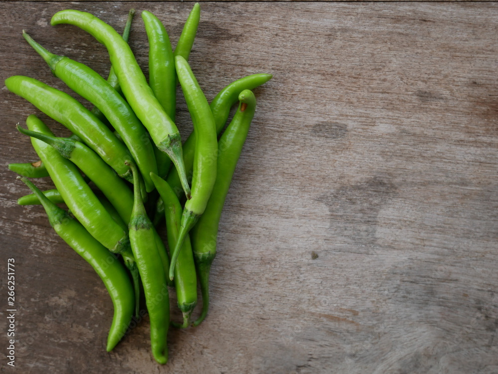 green chili pepper on wooden background green chili pepper on wooden background