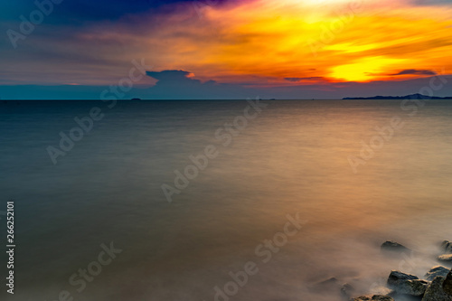 Motion blur of the sea under twilight sunset sky with long exposure effect