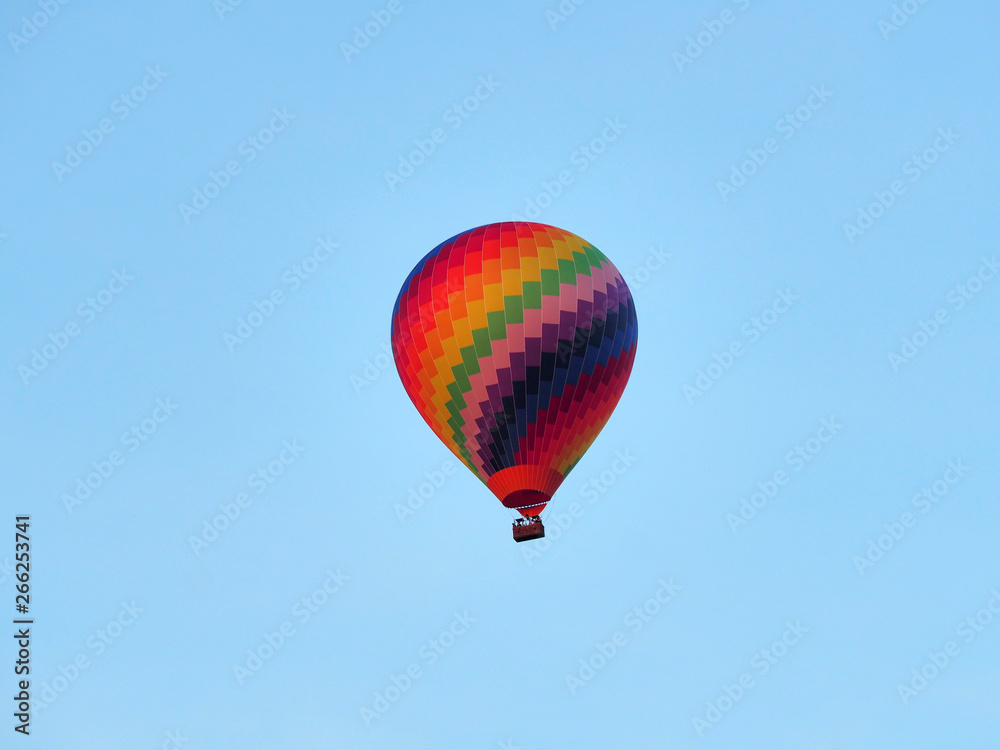 Obraz premium Colorful hot-air balloon in front of a clear blue sky