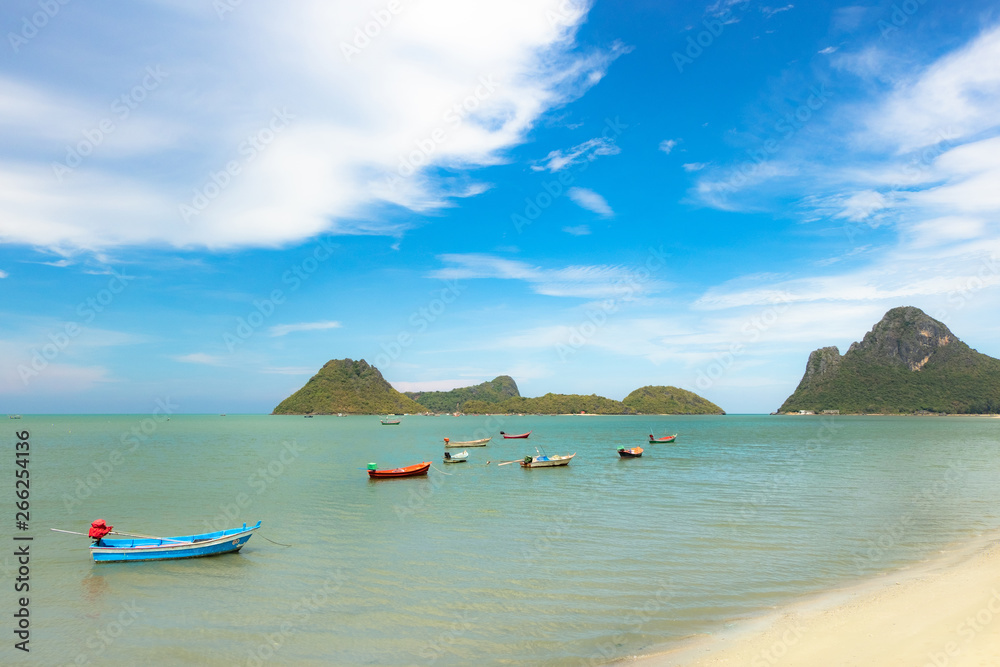 Sea water with fishing boats and blue skies is a beautiful natural summer travel concept.