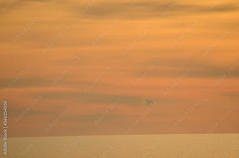 ocean sunset scene with orange and yellow clouds with a burnished sky and calm ocean off Glenelg South Australia ocean sunset scene with orange and yellow clouds with a burnished sky and calm ocean off Glenelg South Australia