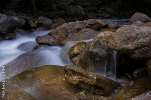 Rocks in stream with smooth flowing water