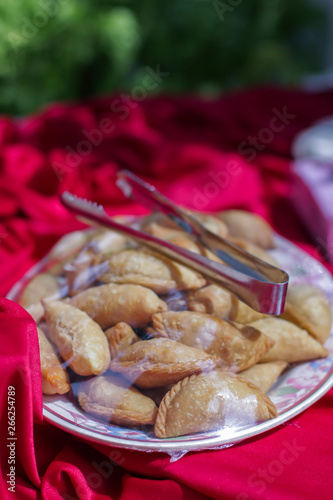 Curry puff covered by plastic on the table.